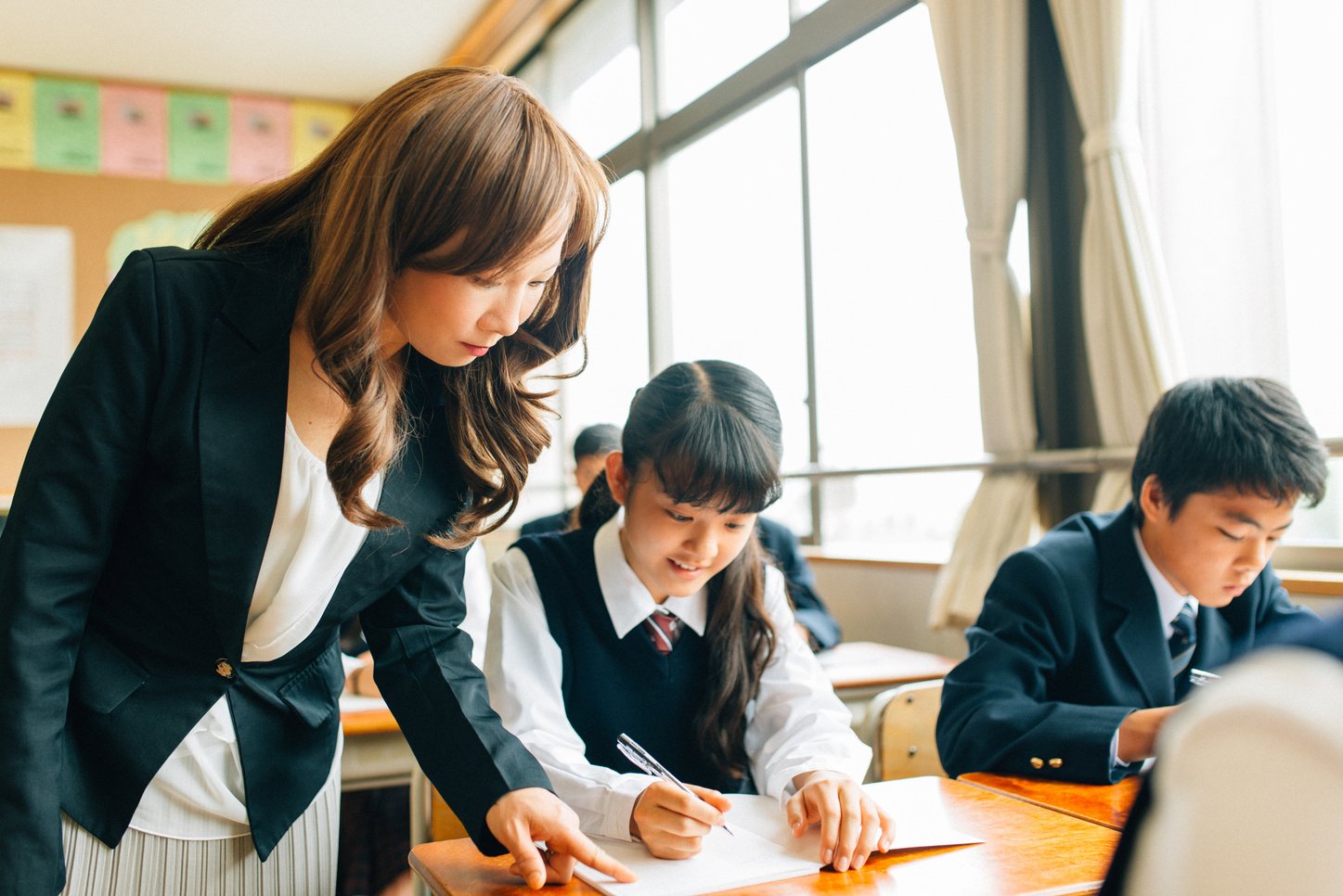 Teacher Assisting Students in Japanese Junior High School